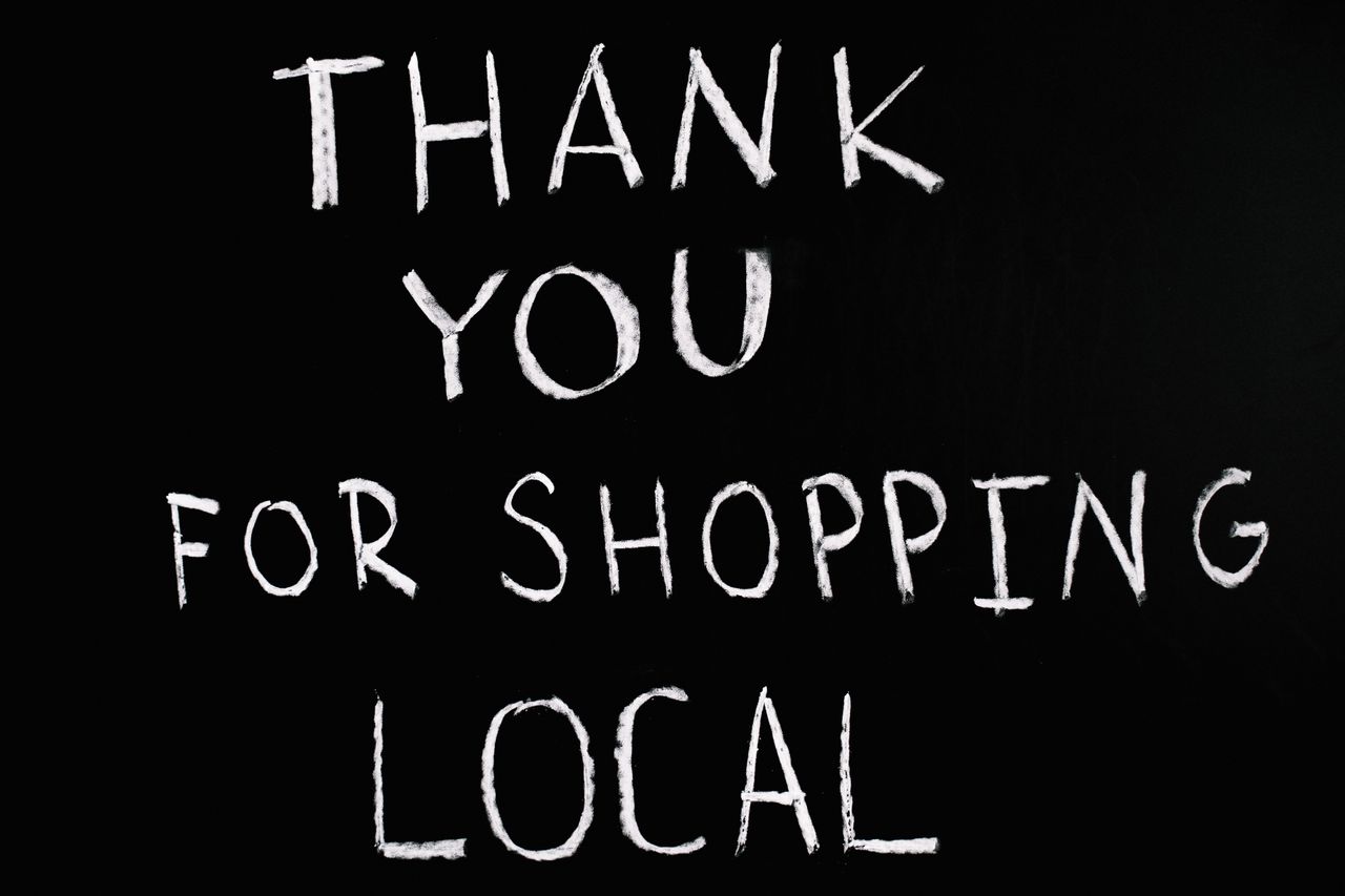 services-05 A chalkboard with handwritten message thanking for supporting local businesses.
